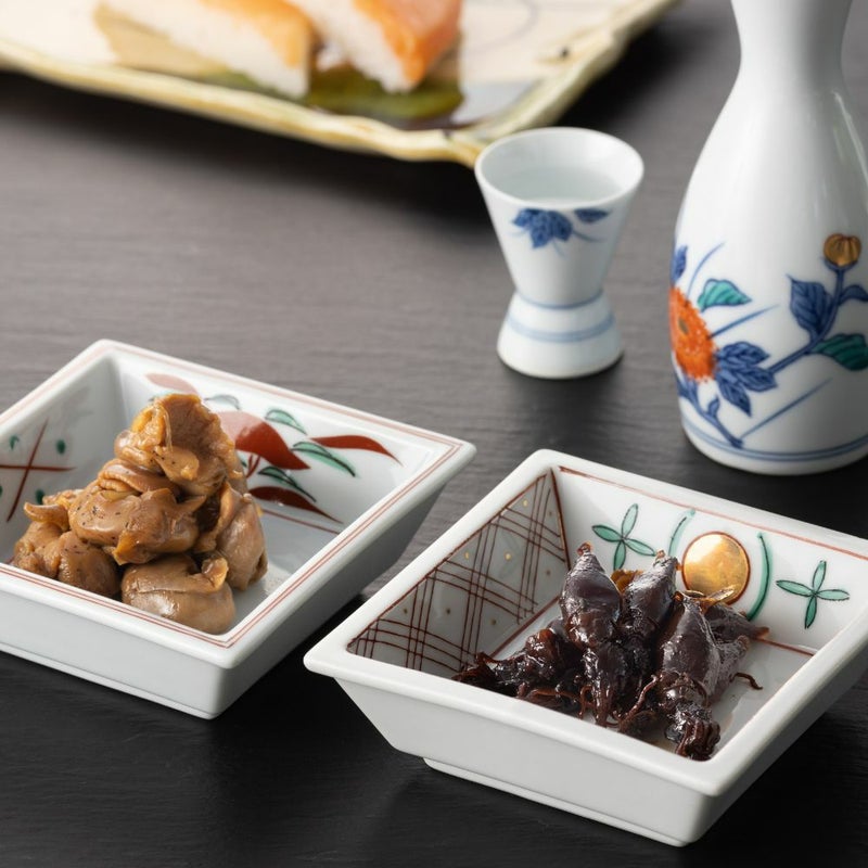 ２種類のうま煮とお酒が並んだ食卓イメージの画像です。